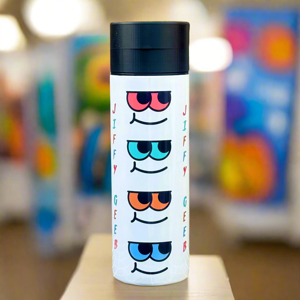 Tumbler with colorful eye designs on a wooden background