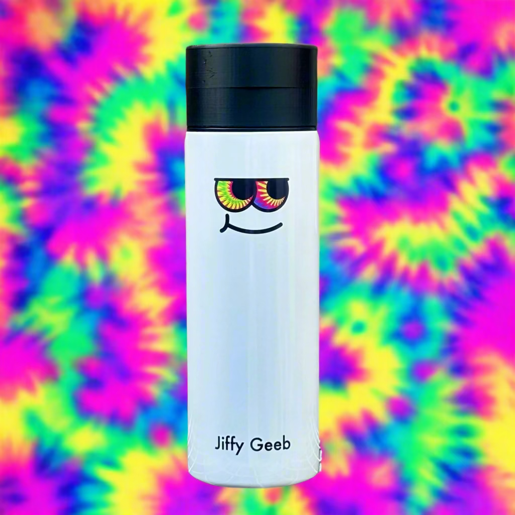 White tumbler with a colorful face design and black lid on a metal rack against a wooden background.