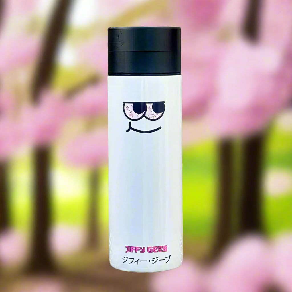 White tumbler with black lid featuring a cartoon face design on a wooden background